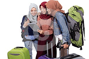 Muslim asian woman friend sitting in airport terminal