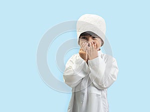 Muslim boy in a dress Seeking blessings to God , isolate background