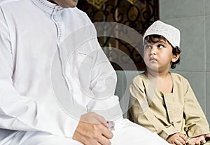 Muslim boy learning how to Salah photo