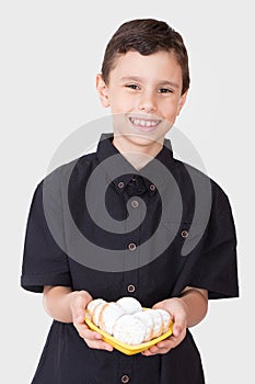 Muslim boy presenting kahk cookies