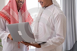 muslim business partner discussing and meeting using laptop