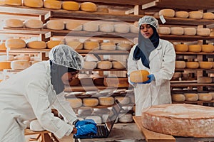 Muslim business partners checking the quality of cheese in the modern industry