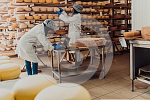 Muslim business partners checking the quality of cheese in the modern industry