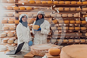 Muslim business partners checking the quality of cheese in the modern industry