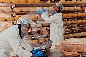 Muslim business partners checking the quality of cheese in the modern industry