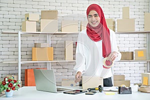 Muslim business woman working in office, Modern Muslim Business Woman, Small business, Online trading and shipping services.