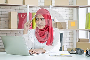 Muslim business woman working in office, Modern Muslim Business Woman, Small business, Online trading and shipping services.