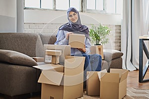 Muslim businesslady getting items from her online shop packaged