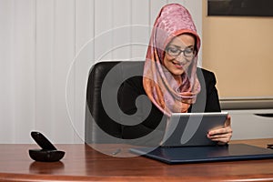 Muslim Businesswoman With Her Touch Pad
