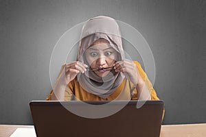 Muslim Businesswoman Working on Laptop Shocked Stunned gesture