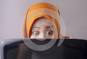 Muslim Businesswoman Working on Laptop Shocked Stunned gesture