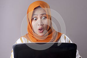 Muslim Businesswoman Working on Laptop Shocked Stunned gesture