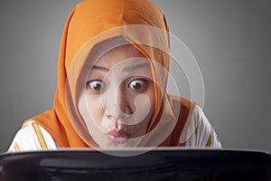 Muslim Businesswoman Working on Laptop Shocked Stunned gesture