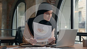 Muslim busy concentrated Islamic woman Arabian girl business analyst female worker manager work papers documents diagram