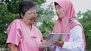 Muslim careful caregivers or doctors hold the tablet to Explain guidelines and treating disease, physical therapy. Concept of