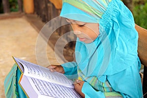 Muslim Child Reading Koran, Indonesia photo