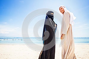 Muslim couple on a beach photo