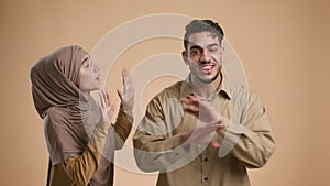 Muslim Couple Having Quarrel Shouting Standing Over Beige Background