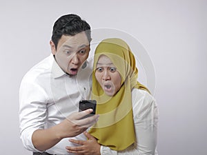 Muslim Couple Shocked Surprised Looking at Smart Phone