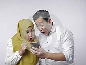 Muslim Couple Shocked Surprised Looking at Smart Phone