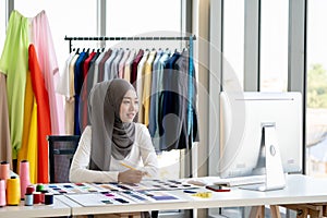 Muslim Creative Fashion Designer is Working owner working in her Tailor Shop