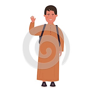 Muslim cute schoolboy in traditional clothes standing, boy waving with smile