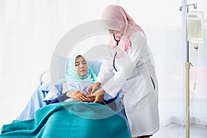 A Muslim doctor is giving the saline solution