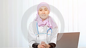 Muslim doctor in hijab with excitement works in clinic