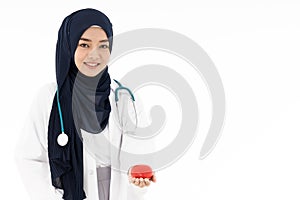 Muslim doctor hold red heart