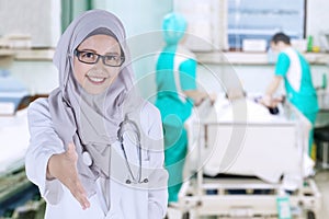 Muslim doctor offering handshake in the hospital