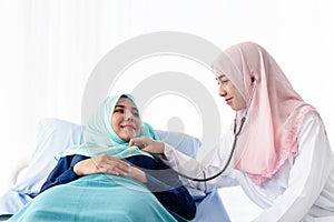 Muslim doctor using stethoscope listen heartbeat