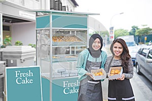 Muslim entrepreneur with partner starting food stall business