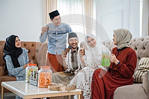 Muslim families get together celebrating Idul Fitri by at home