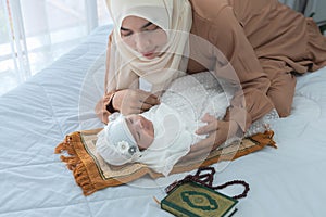 Muslim family, Asian mother feeding bottle milk to 2 month old newborn baby