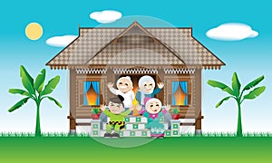 A Muslim family celebrating Raya festival in their traditional Malay style house. With village scene.