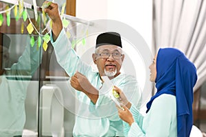 Muslim family decorating home for Eid al-Fitr