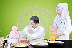 Muslim family eating together