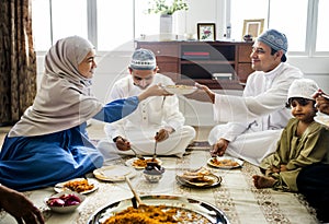 Muslim family having dinner on the floor photo