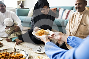 Muslim family having dinner on the floor photo