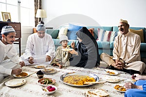 Muslim family having dinner on the floor photo