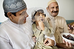 Muslim family having dried dates as a snack photo