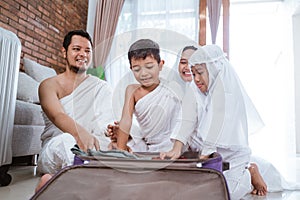 Muslim family packing for umrah and hajj photo