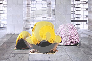 Muslim family posing prostration in the mosque photo