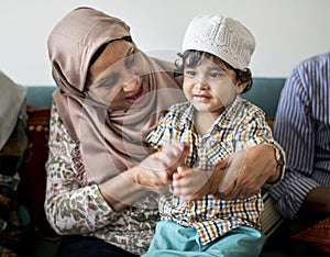 Muslim family relaxing in the home