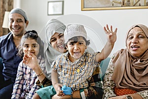 Muslim family relaxing and playing at home photo