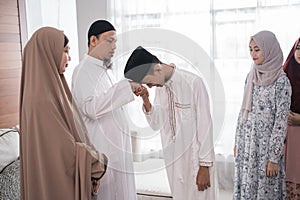 Muslim family shake hand apologizing during the Eid mubarak