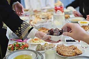 Muslim family starting iftar with dates during Ramadan