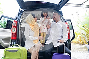 Muslim family with suitcase before traveling