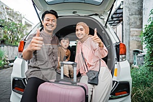muslim family with suitcase before traveling thumb up