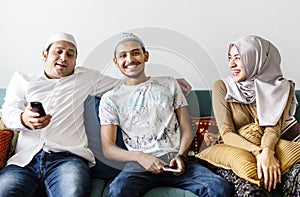 Muslim family watching tv at home photo